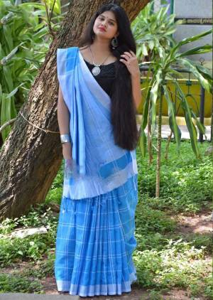 For Your Casual Or Semi-Casual Wear, Grab This Pretty Light Weight Saree In Light Blue Color Paired With Black Colored Blouse. This Saree And Blouse Are Fabricated On Cotton Linen Beautified With Checks Prints all Over. 
