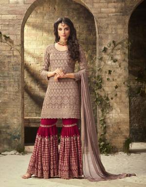 New Shade In Purple Is Here With This Designer Sharara Suit In Mauve Colored Top And Dupatta Paired With Contrasting Magenta Pink Colored Bottom. Its Top And Bottom Are Georgette Based Paired With Chiffon Dupatta Beautified With Heavy Embroidery.