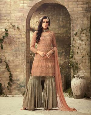 A Must Have Color Pallete To Add Into Your Wardrobe With This Designer Sharara Patterned Suit In Peach Colored Top And Dupatta Paired With Contrasting Grey Colored Bottom. Its Top and Bottom are Fabricated On Georgette Beautified With Heavy Embroidery Paired With Chiffon Dupatta.