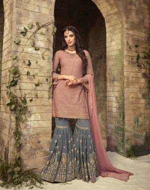 Look Pretty Wearing This Designer Semi-Stitched Suit In Dusty Pink Colored Top And Dupatta Paired With Contrasting Dark Grey Colored Sharara. Its Heavy Embroidered Top And Bottom are Fabricated On Georgette Paired With Chiffon Dupatta. Buy Now.
