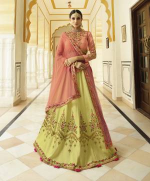 For This Festive Season, Grab This Heavy Designer Lehenga Choli In Dark Peach Colored Blouse And Dupatta Paired With Contrasting Yellow Colored Lehenga. This Lehenga Is Soft Silk Based Paired With Art Silk Blouse And Net Dupatta. Buy Now.