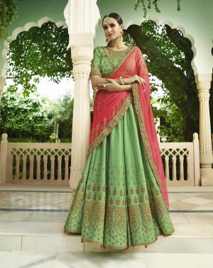 Celebrate This Festive Season with This Beautiful Designer Lehenga Choli In Green Color Paired With Contarsting Crimson Red Colored Dupatta. Its Blouse Are Lehenga Are Fabricated On Soft Silk Paired With Net Dupatta. It Is Light Weight And Easy To Carry Throughout The Gala.