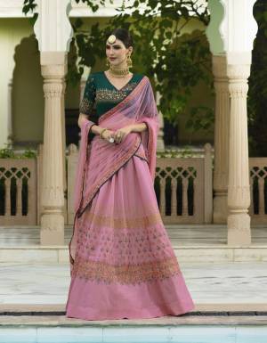 Celebrate This Festive Season with This Beautiful Designer Lehenga Choli In Green Colored Blouse, Paired With Contarsting Pink  Colored Lehenga And Dupatta. Its Blouse Are Lehenga Are Fabricated On Art Silk Paired With Net Dupatta. It Is Light Weight And Easy To Carry Throughout The Gala.