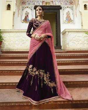 To Give A Royal Look To Your Personality, Grab This Heavy Deisgner Lehenga Choli In Dark Wine Color Paired With Contrasting Pink Colored Dupatta. Its Lehenga And Choli Are Velvet Based Paired With Net Dupatta. Buy This Attractive Lehenga Choli Now.