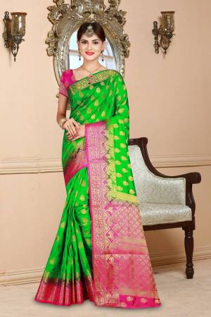 Celebrate This Festive Season Wearing This Lovely Saree In Green Color Paired With Contrasting Rani Pink Colored Blouse. This Saree And Blouse Are Art Silk Based Beautified With Weave All Over.
