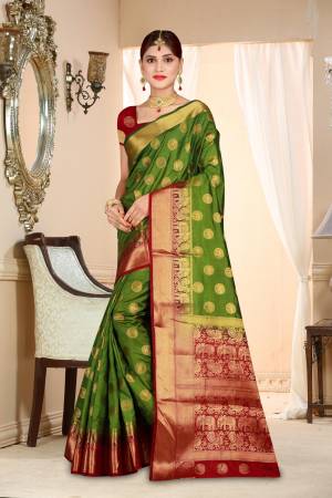 Celebrate This Festive Season Wearing This Lovely Saree In Dark Green Color Paired With Contrasting Maroon Colored Blouse. This Saree And Blouse Are Art Silk Based Beautified With Weave All Over.