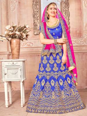 Bright and Visually Appealing Color Is Here With This Heavy Designer Lehenga Choli In Royal Blue Color Paired With Contrasting Dark Pink Colored Dupatta. This Lehenga Choli Is Art Silk Based Paired With Net Fabricated Dupatta. Buy Now.
