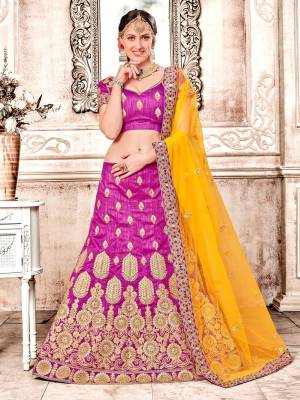 Celebrate This Festive And Wedding Season Wearing This Heavy Designer Magenta Pink Colored Lehenga Choli Paired With Contrasting Yellow Colored Dupatta. Its Blouse And Lehenga Are Fabricated On Art Silk Paired With Net Fabricated Dupatta. Buy Now.