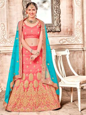 New Color Pallete In Lehenga Choli Is Here With This Designer Lehenga Choli In Dark Peach Color Paired With Contrasting Turquoise Blue Colored Dupatta. Its Blouse And Lehenga Are Art Silk Based Paired With Net Fabricated Dupatta. Buy Now.