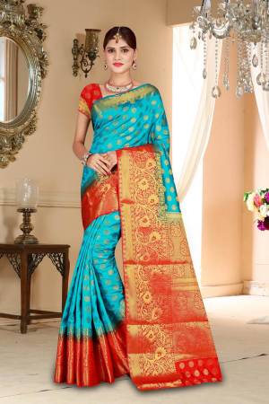Flaunt Your Rich And Elegant Taste Wearing This Pretty Art Silk Based Saree In Turquoise Blue Color Paired With Contrasting Red Colored Blouse. This Saree And Blouse Are Beautified With Weave Making It More Attractive. 
