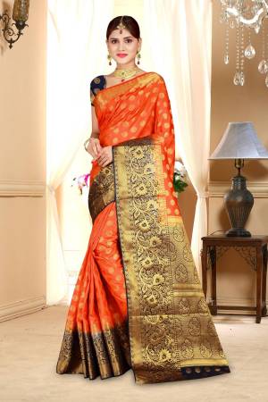 Celebrate This Festive Season Wearing This Bright And Attractive Art Silk Based Saree In Orange Color Paired With Contrasting Black Colored Blouse. This Saree And Blouse Are Beautified With Weave All Over.