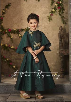 For You And Your Daughter, Grab This Designer Floor Length Gown In Pine Green Color Fabricated On Satin Silk Which Is Comfortable For Both Adult And Kids. Its New Cape Sleeve Pattern Will Earn You And Your Daughter Lots Of Compliments From Onlookers.