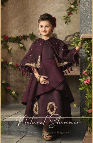 A Must Have Shade For You And Your Daughter Is Here In Wine Color Fabricated On Satin Silk. Its Beautiful Cape Pattern And Embroidery Is Making The Gown More Attractive. And You And Your Daughter Will Definitely Earn Lots Of Compliments From Onlookers. 