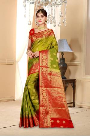 Add This Beautiful Shade In Green To Your Wardrobe With This Olive Green Colored Saree Paired With Contrasting Red Colored Blouse. This Saree And Blouse Are Fabricated On Art Silk Beautified With Weave All Over. Buy This Saree Now.