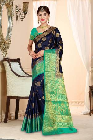 Enhance Your Personality Wearing This Silk Based Saree In Navy Blue Color Paired With Contrasting Sea Green Colored Blouse. This Saree And Blouse Are Fabricated On Art Silk Beautified With Weave All Over .