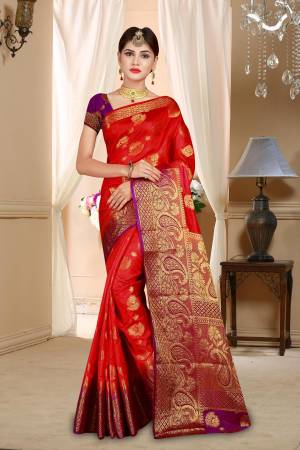 Adorn The Angelic Look This Season With This Beautiful Silk Based Saree In Red Color Paired With Contrasting Purple Colored Blouse. This Saree And Blouse Are Fabricated On Art Silk Beautified With Weave All Over. 