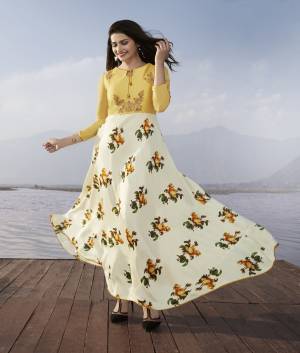 Grab This Designer Long Kurti In White And Yellow Color Fabricated On Satin Georgette. It Is Beautified With Floral Prints And Embroidery Over The Yoke. Buy Now.
