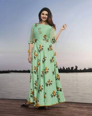 Look Pretty In This Designer Floor Length Readymade Kurti In Light Green Color Fabricated On Satin Georgette Beautified With Prints And Embroidery. It Is Available In All Regular Sizes. Buy Now.