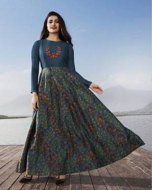 New Shade In Blue Is Here To Add Into Your Wardrobe With this Designer Long Kurti In Prussian Blue Color Fabricated On Satin Georgette It Has Pretty Prints All Over With Embroidered Yoke. 