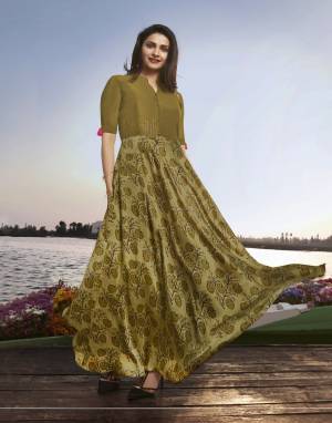 New Shade In Green Is Here To Add Into Your Wardrobe With this Designer Long Kurti In Olive Green Color Fabricated On Satin Georgette It Has Pretty Prints All Over With Embroidered Yoke. 