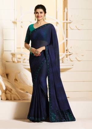Enhance Your Personality Wearing This Designer Saree In Navy Blue Color Paired With Turquoise Blue Colored Blouse. This Saree Is Georgette Based Paired With Art Silk Fabricated Blouse. It Has Attractive Stone Work Over The Saree And Blouse.