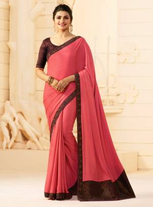 Bright And Visually Appealing Color Is Here With This Lovely Pink Colored Saree Paired With Contrasting Maroon Colored Blouse. This Saree Is Fabricated On Georgette Paired With Art Silk Fabricated Blouse. 