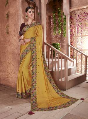 Celebrate This Festive Season Wearing This Beautiful Saree In Musturd Yellow Color Paired With Contrasting Brown Colored Blouse. This Saree And Blouse Are Art Silk Based Beautified With Embroidery. 