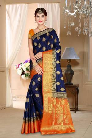 Enhance Your Personality Wearing This Silk Based Saree In Navy Blue Color Paired With Contrasting Orange Colored Blouse. This Saree And Blouse are Fabricated On Art Silk Beautified With Weave All Over. Buy This Saree Now.