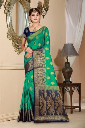 Here Is an Attractive Sea Green Colored Saree Paired With Contrasting Navy Blue Colored Blouse. This Saree And Blouse Are Fabricated On Art Silk Beautified With Weave All Over. Buy Now.