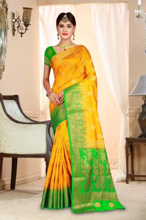 Celebrate This Festive Season Wearing This Attractive Looking Saree In Yellow Color Paired With Contrasting Green Colored Blouse. This Saree And Blouse are Art Silk Based Beautified With Weave.
