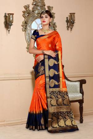 Celebrate This Festive Season Wearing This Attractive Looking Saree In Orange Color Paired With Contrasting Navy Blue Colored Blouse. This Saree And Blouse are Art Silk Based Beautified With Weave.