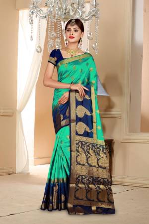 Here Is an Attractive Sea Green Colored Saree Paired With Contrasting Navy Blue Colored Blouse. This Saree And Blouse Are Fabricated On Art Silk Beautified With Weave All Over. Buy Now.
