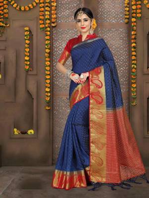 Enhance Your Personality In This Navy Blue Colored Saree Paired With Contrasting Red Colored Blouse. This Saree And BlouseAre Fabricated On Embossed Jacquard Which Itself Is An Attractive Fabric. Buy It Now.