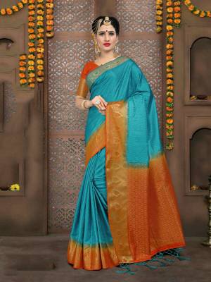 Add This Silk Based Saree To Your Wardrobe In Sky Blue Color Paired With Contrasting Orange Colored Blouse. This Saree And Blouse Are Fabricated On Embossed Jacquard Which Is Light Weight And Easy To Carry All Day Long.