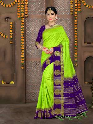 Catch All The Limelight Wearing This Silk Based Attractive Saree In Parrot Green Color Paired With Contrasting Violet Colored Blouse. This Saree And Blouse are Fabricated On Art Silk Beautified With Weave. 