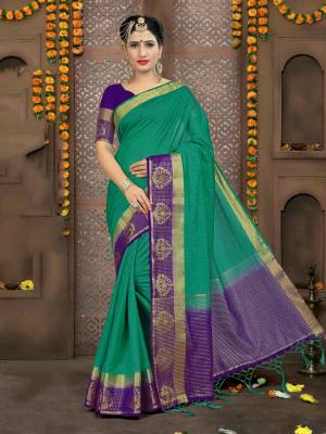 For A Rich, Simple And Elegant Look, Grab This Saree In Teal Green Color Paired With Contrasting Purple Colored Blouse. This Saree And Blouse Are Linen Based Which Is Easy To Drape And Durable.