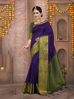 A Must Have Shade In Every Womens Wardrobe Is Here With This Saree In Violet Color Paired With Contrasting Olive Green Colored Blouse. This Saree And Blouse Are Art Silk Based Beautified With Attractive Lace Border. 