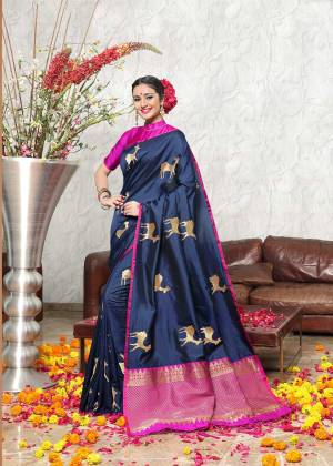 Enhance Your Personality In This Silk Based Saree In Navy Blue Color Paired With Contrasting Rani Pink Colored Blouse. This Saree And Blouse Are Fabricated On Banarasi Art Silk Beautified with Weave All Over It. Buy This Saree Now.