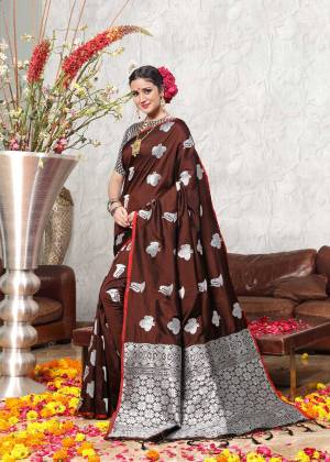 Enhance Your Personality In This Silk Based Saree In Navy Blue Color Paired With Contrasting Silver And Brown Colored Blouse. This Saree And Blouse Are Fabricated On Banarasi Art Silk Beautified with Weave All Over It. Buy This Saree Now.