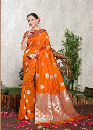 Celebrate This Festive Season With Ease And Comfort Wearing This Bright Orange Colored Saree Paired With Orange Colored Blouse. This Saree And Blouse are Banarasi Art Silk Based Which Is Light Weight And eAsy To Carry Throughout The Gala.