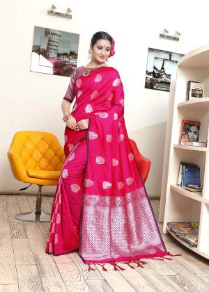 Shine Bright In This Lovely Fuschia Pink Colored Saree Paired With Silver And Fucshia Pink Colored Blouse. This Saree And Blouse are Banarasi Art Silk based Beautified With Weave All Over IT .