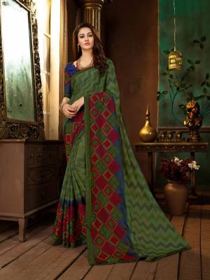 Buy This Lovely Saree In Green Color Paired With Contrasting Royal Blue Colored Blouse. This Saree Is Fabricated On Georgette Paired With Art Silk Fabricated Blouse. It Is Beautified With Prints And Thread Work. 