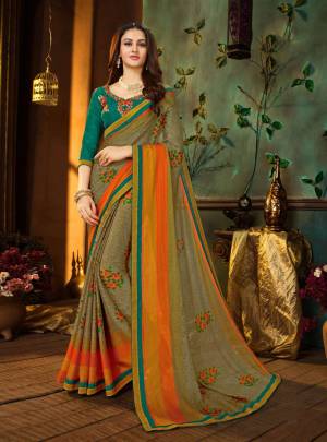 New Color Pallete Is Here With This Saree In Grey And Orange Color Paired With Contrasting Turquoise Blue Colored Blouse. This Saree Is Georgette Fabricated Paired With Art Silk Blouse. 
