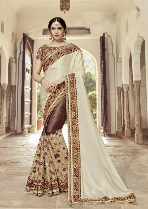Flaunt a new ethnic look wearing this Cream And maroon color satin georgette with glitter and lycra saree. this party wear saree won't fail to impress everyone around you. this gorgeous saree featuring a beautiful mix of designs. Its attractive color and heavy designer embroidered saree, moti design, also heavy designer blouse, cut paste design saree, beautiful floral design all over work over the attire & contrast hemline adds to the look. Comes along with a contrast unstitched blouse.