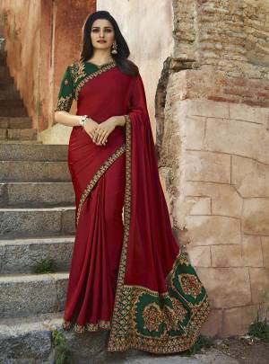 For A Proper Ethnic Look, Grab This Designer Saree In Maroon Color Paired With Contrasting Dark Green Colored Blouse. This Saree Is Fabricated On Soft Silk Paired With Art Silk Fabricated Blouse. It Has Heavy Embroidered Pallu And Blouse With Elegant Lace Border.
