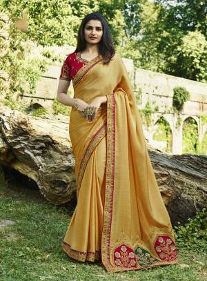 Celebrate This Festive Season Wearing This Designer Saree In Yellow Color Paired With Contrasting Dark Pink Colored Blouse. This Saree Is Soft Silk Based Paired With Art Silk Fabricated Blouse. Its Attractive Color Pallete And Embroidery Is Giving A Lovely Touch The Saree.