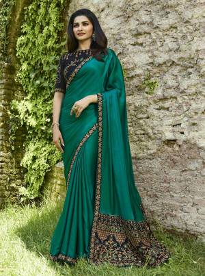 Grab This Beautiful Designer Saree For The Upcoming Festive And Wedding Season With This Designer Saree In Teal Green Color Paired With Contrasting Navy Blue Colored Blouse. This Saree Is Fabricated On Soft Silk Paired With Art Silk Fabricated Blouse. 