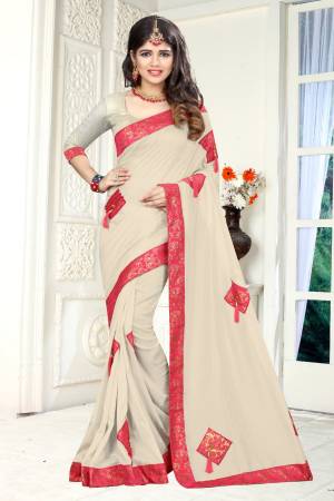 Simple And Elegant Looking Designer Saree Is Here In Off-White Color Paired With Off-White Colored Blouse. This Saree And Blouse Are Fabricated On Soft Silk Beautified With Patches, Buttons And Tassels.