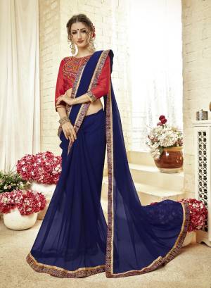Shine Bright Wearing This Designer Saree In Royal Blue Color Paired With Contrasting Red Colored Blouse. This Saree Is Fabricated On Georgette Paired With Art Silk Fabricated Blouse. It Is Beautified with  Contrasting Thread Work Over The Blouse. 