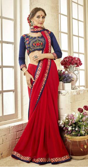 Adorn The Pretty Angelic Look Wearing This Designer Saree In Red Color Paired With Contrasting Navy Blue Colored Blouse. This Saree Is Fabricated On Georgette Paired With Art Silk Fabricated Blouse. It Has Attractive Thread Work Over Its Blouse. 